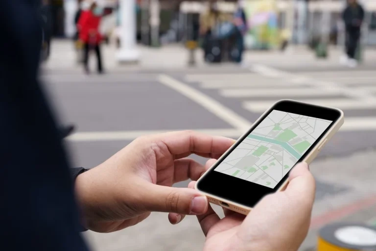 Person viewing a maps app on their phone while on the street