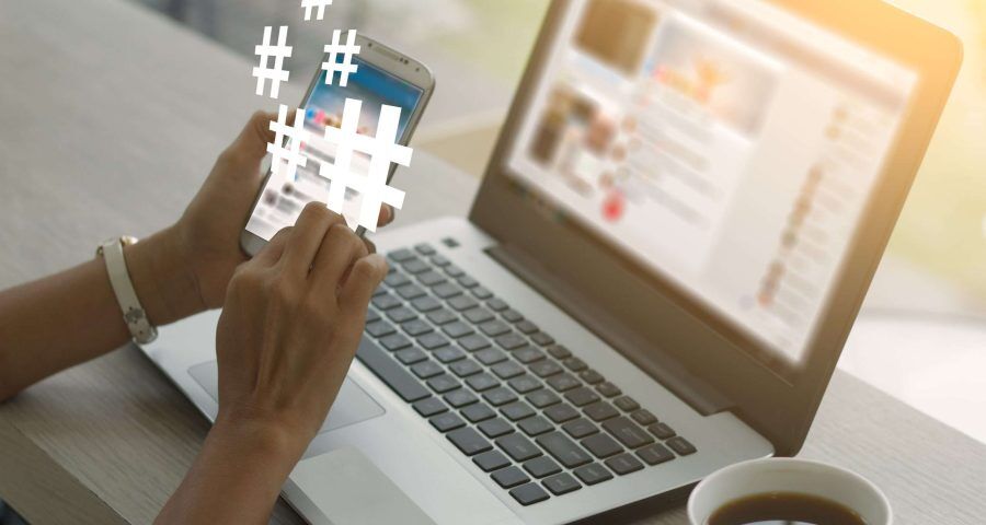 woman on her phone with hashtags lighting up