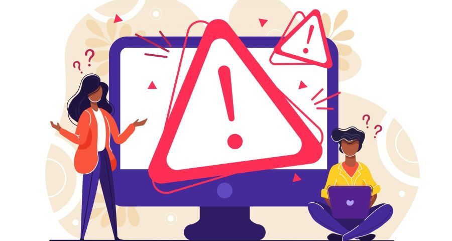 Two people stand next to a computer monitor with a red caution triangle displayed in the middle. This graphic is meant to represent a website error.