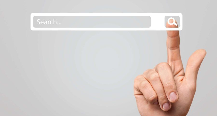 finger pointing to search button on search engine