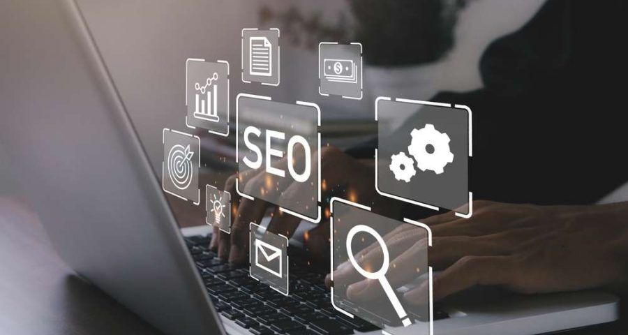 A worker types away at a laptop, where a silhoutted illustration appears above the keyboard highlighting SEO and the numerous components of a good strategy (email marketing, search rankings, paid ads, and analytics)