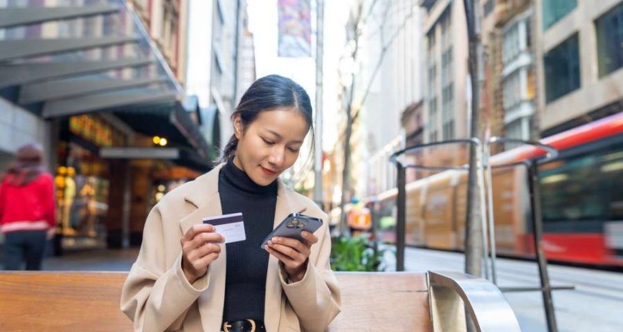 Asian,Woman,Using,Mobile,Phone,With,Credit,Card,Booking,Hotel