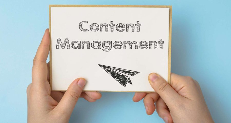 close up of a person holding a content management sign