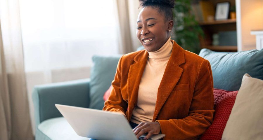 Content,Young,Businesswoman,Typing,On,A,Laptop,,Writing,An,E-mail,