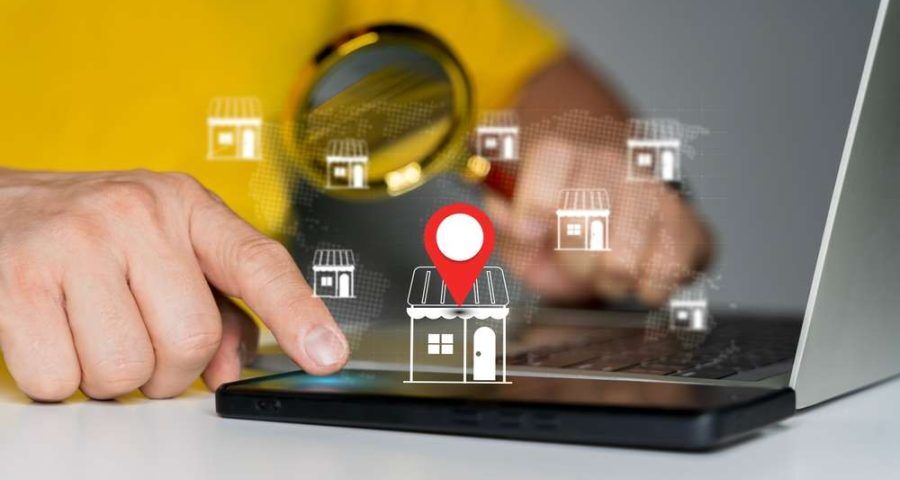 A person using a keyboard to conduct a local listing search, with relevant graphics popping up from the keyboard