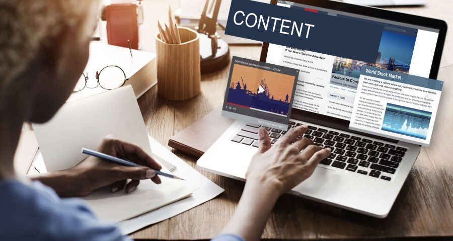 person writing web content on laptop