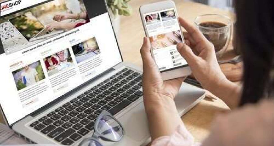 Woman shopping on her computer and phone.