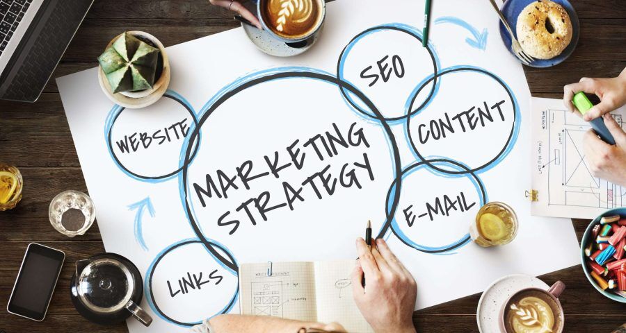 Team drawing marketing plan on paper