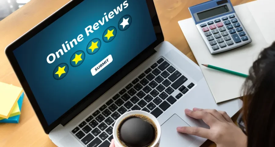 Online reviews pictured on a laptop with coffee cup nearby
